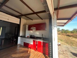 a kitchen with red cabinets and a counter top at Nature's Abode in Pune
