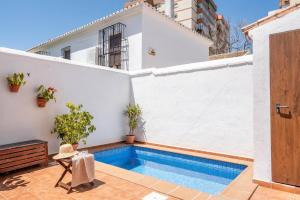 a swimming pool in the backyard of a house at Casa Pueblo Lopez in Fuengirola