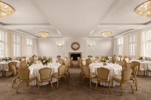 a banquet room with tables and chairs and a fireplace at The Stoneleigh, Autograph Collection in Dallas +88 photos