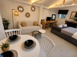 a room with a bed and a living room at Marcia's Welcome House in Rafina +12 photos