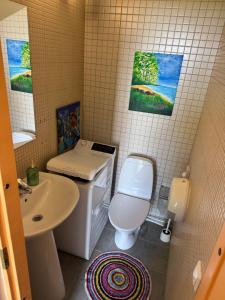a small bathroom with a toilet and a sink at Villa Meri Apartments in Pärnu +38 photos