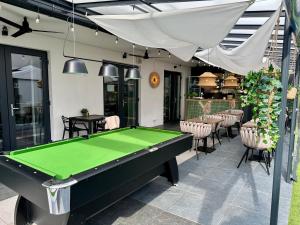 a pool table in the middle of a patio at Villa Nautica in Łeba