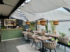 a restaurant with tables and chairs under a white tent at Villa Nautica in Łeba
