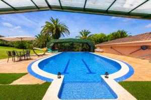 a swimming pool in a backyard with a house at Basque Palace, Mansion con Jardín, Barbacoa, Gimnasio, Piscina, Sauna in Mungia