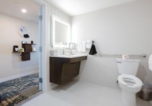 a white bathroom with a toilet and a sink at Radisson Hotel Santa Maria in Santa Maria +45 photos