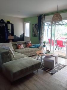 a living room with a couch and a table at Gite du gachou in Souillac