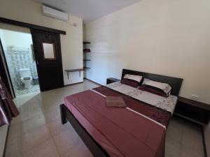 a bedroom with a large bed in a room at Popeye Karimunjawa in Karimunjawa