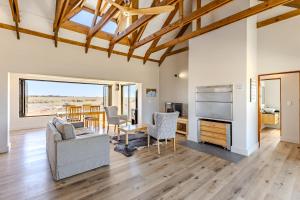 a living room with a couch and a table at Quagga River Lodge in Velddrif