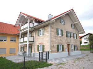 a large brick building with a fence in front of it at Guade Stub'n Franzi in Huglfing