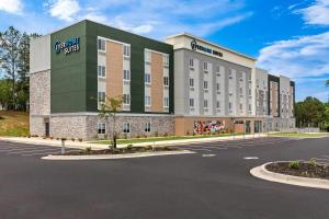 a rendering of a building with a parking lot at Everhome Suites Stockbridge Atlanta in Stockbridge