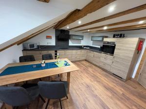 a large kitchen with a wooden table and chairs at Ferienwohnung Rief in Tannheim