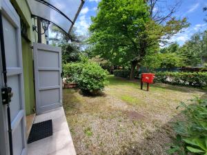 a door to a house with a yard with trees at Residence Villa Stufler in Modena