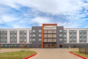 a large building with a sign that reads cancer hospital at Cambria Hotel Euless - DFW Airport South in Euless