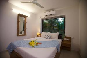 a bedroom with a large bed with a window at 4BHK Villa in Anjuna with Jacuzzi & Pool in Anjuna