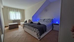 a bedroom with a bed with a blue light at Casa Mariangela pool and garden in Leggiuno +15 photos