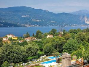 a resort with a swimming pool and a lake at Casa Mariangela pool and garden in Leggiuno