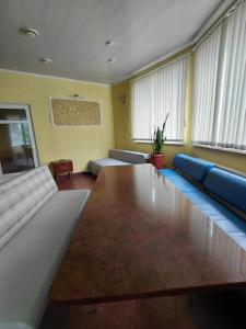 a living room with a couch and a table at Dlya Vseh Motel in Kamianets-Podilskyi