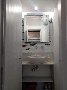 a bathroom with a sink and a mirror at Μαγαζάκι in Tripótamos