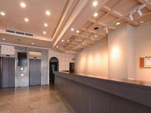 a lobby with a long counter in a building at Guide Hotel Changhua Jhongjheng in Changhua City