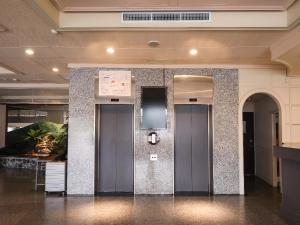 a lobby with two elevators in a building at Guide Hotel Changhua Jhongjheng in Changhua City