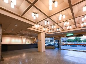 an empty lobby of a building with lights on the ceiling at Guide Hotel Changhua Jhongjheng in Changhua City