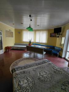 a living room with a couch and a pool table at Dlya Vseh Motel in Kamianets-Podilskyi