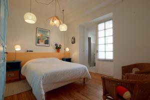 a bedroom with a white bed and a window at Etche alabena - 2 in Ainhoa