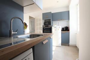 a kitchen with a sink and a refrigerator at Etche alabena - 2 in Ainhoa