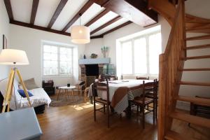 a living room with a table and chairs and a fireplace at Etche alabena - 2 in Ainhoa
