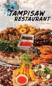 a table full of different types of food at S&L Lodging House and Tampisaw Restaurant in Pandan