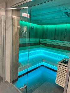 a swimming pool with blue lighting in a bathroom at Xavers Ranch in Meschede