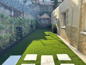 a courtyard with green grass in a building at Le AVRA MONTIS in Galata +52 photos