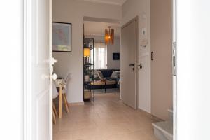 a hallway with a hallway leading to a living room at Phoebes Place At Kalamaki Court, 2 Bedroom Villa With A Shared Pool - Fully Refurbished For 2026 in Kalamaki