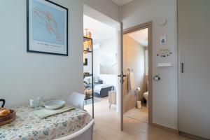 a living room with a table and a hallway at Phoebes Place At Kalamaki Court, 2 Bedroom Villa With A Shared Pool - Fully Refurbished For 2026 in Kalamaki