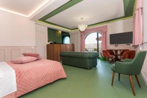 a bedroom with a bed and a tv and a table at Monforte's Etna Loft in Piedimonte Etneo