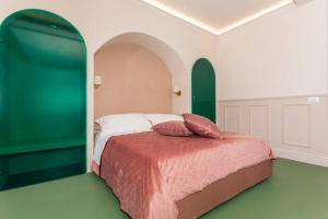 a bedroom with a bed with a green wall at Monforte's Etna Loft in Piedimonte Etneo