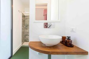 a bathroom with a white bowl sink on a wooden counter at Monforte's Etna Loft in Piedimonte Etneo +16 photos