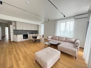 a living room with a couch and a table at River View Apartment in the Park in Marijampolė