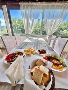 a table with plates of food on top of it at Ergi Riverside Villas in Zues