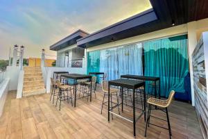 a balcony with tables and chairs on a house at Lighthouse Point Hotel in Dumaguete +5 photos