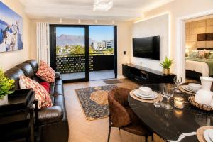 a living room with a couch and a table at ZALS- Nine Palms -Luxury Two Bed in Cape Town