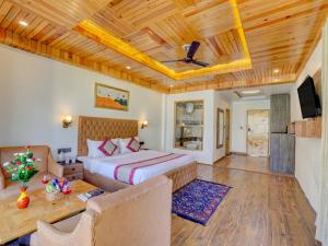 a bedroom with a bed and a couch in a room at Bliss of Heaven in Jagatsukh +61 photos