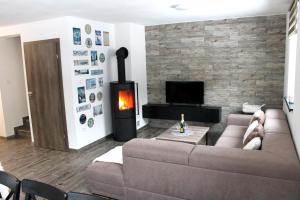 a living room with a couch and a fireplace at Oščadnica, Tadorka in Čadca