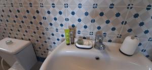 a bathroom with a white sink and a toilet at Citadel Boutique Hotel in Amman +6 photos