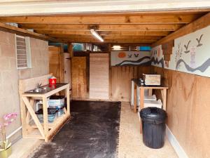 a small room with a sink and two tables at Flow Dome at Estuary Escapes in Kingsbridge