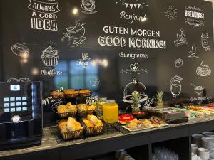 a bakery with a counter with pastries and other foods at Motel Blue Messe in Berlin +56 photos