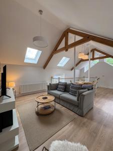 a living room with a couch and a table at Westfield Barn in Cashel