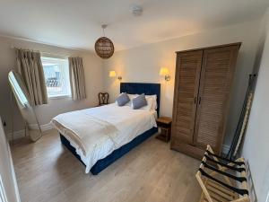 a bedroom with a large bed and a window at Westfield Barn in Cashel