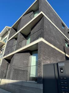 a brick building with a parking meter in front of it at Premium T1 - Blue Ocean in Espinho