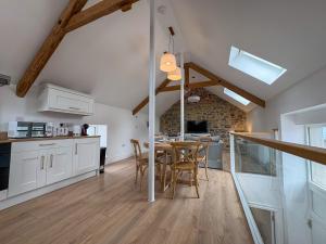 a kitchen and dining room with a table and chairs at Westfield Barn in Cashel